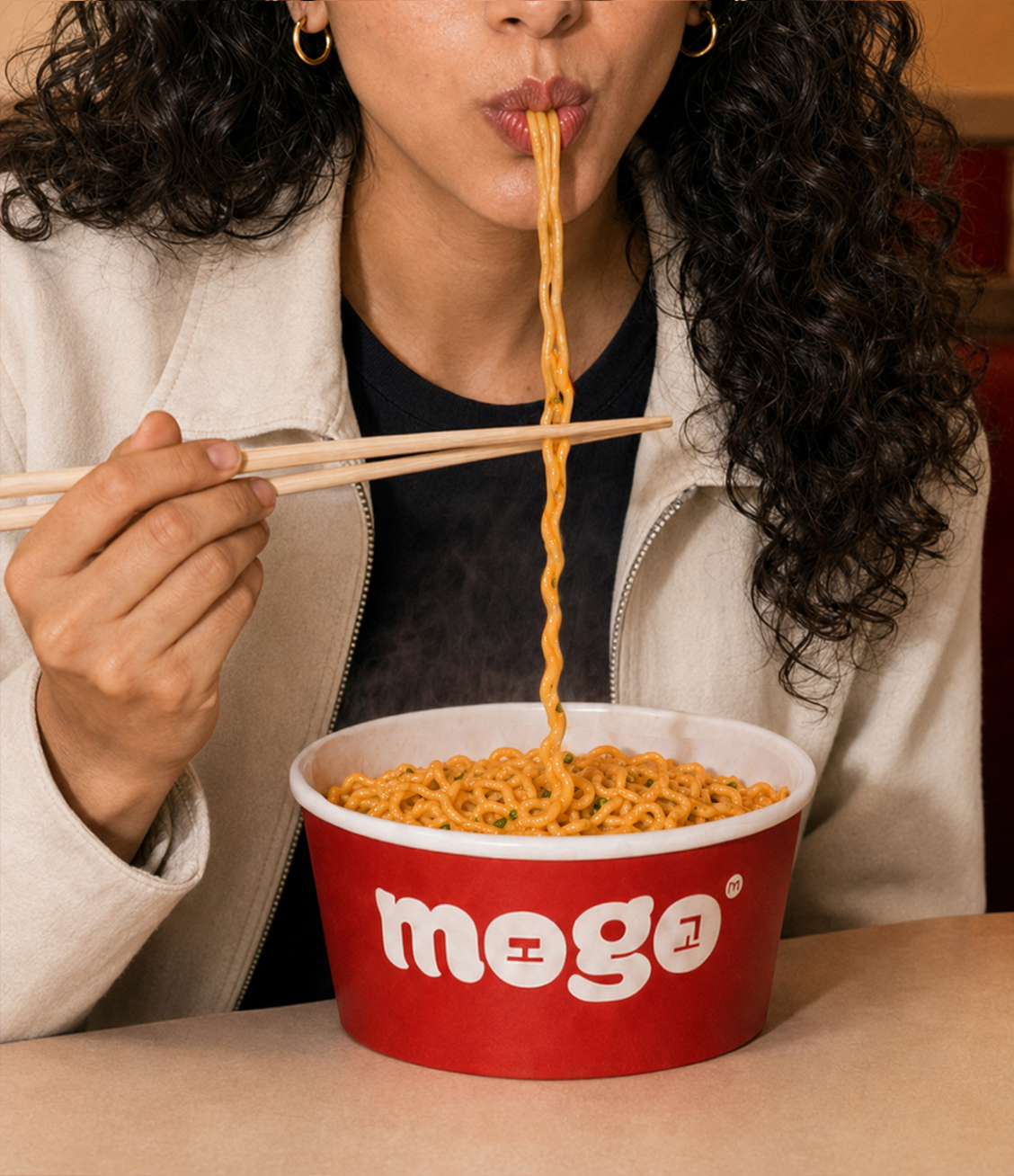 Character B eating noodles from a MOGO bowl