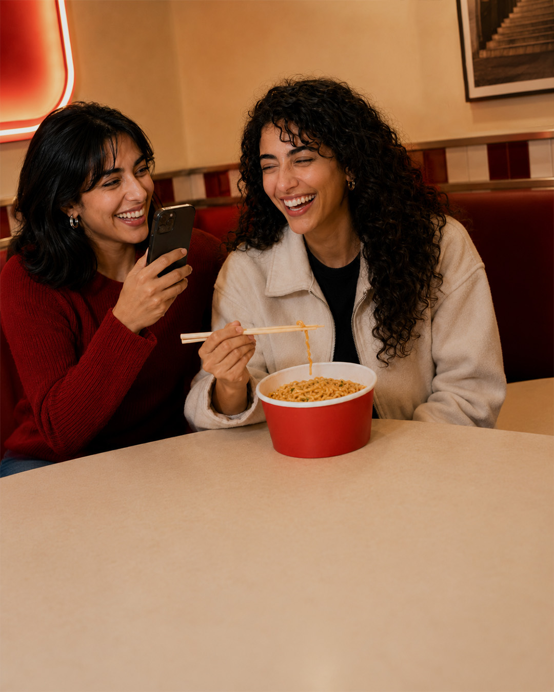Raw MOGO campaign generation showing two friends laughing over a bowl without final brand treatment